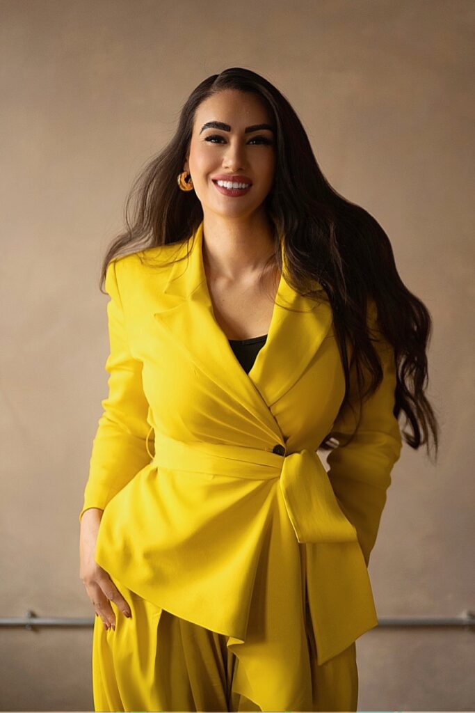 Scarlett Allen Horton BBC Apprentice finalist, pictured standing wearing a bright yellow tailored suit