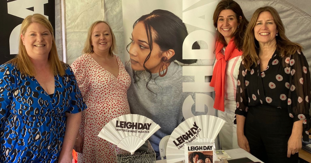 leigh day team at stood beside display banner with promotional materials