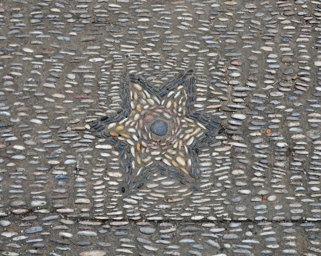 a star shape displayed in a pebble mosaic