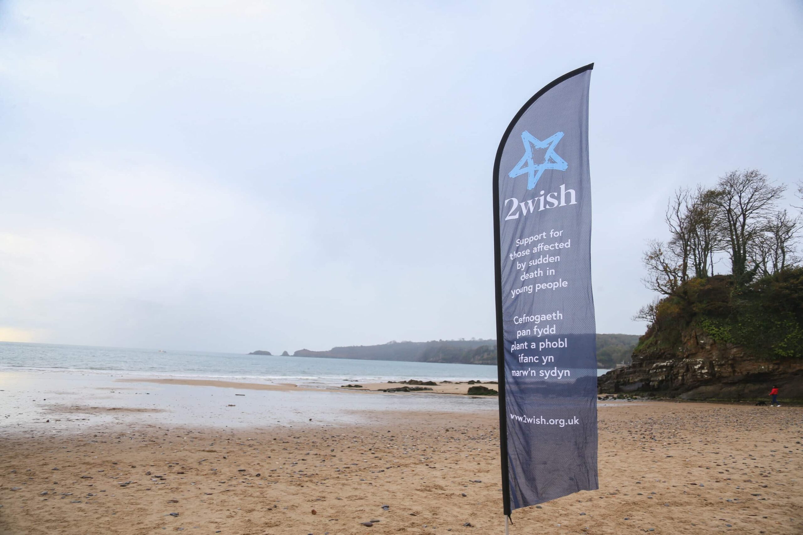 A 2wish flag on a sandy beach