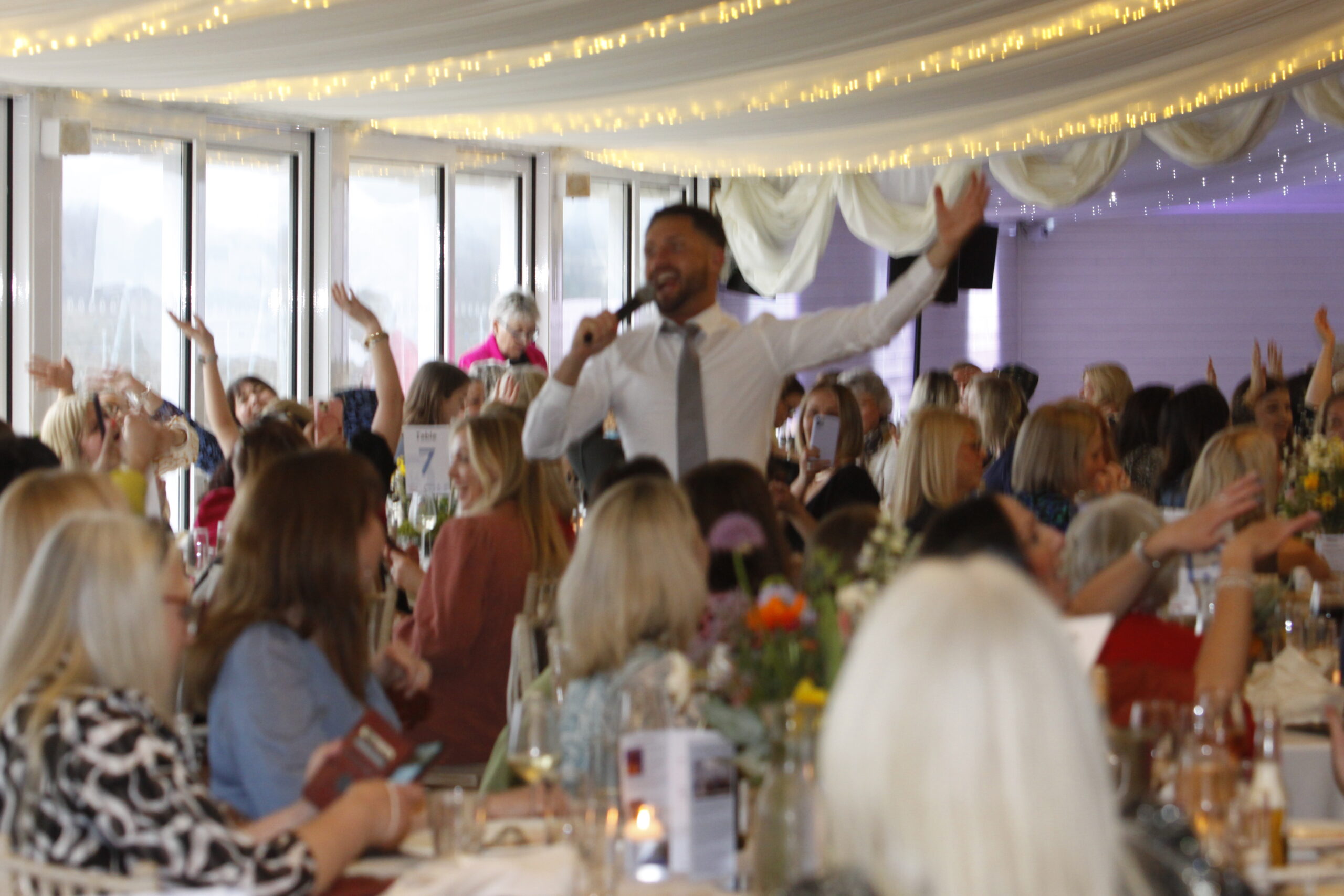 A man with a microphone at international women's day event