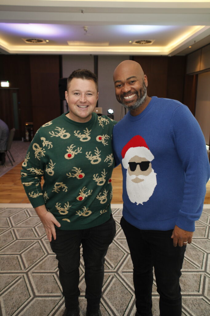 2 men in Christmas jumpers at the festive soiree event