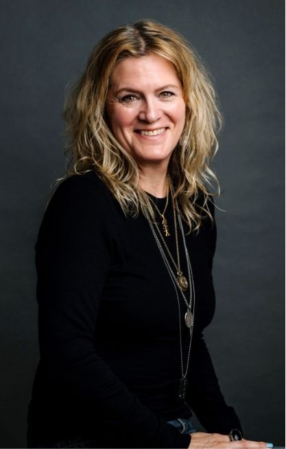 A photo of Jane Tranter in a dark room, dressed in black