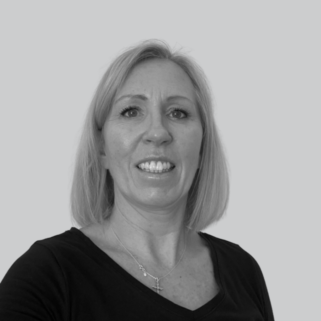 A selfie of Lisa Caradine on a plain grey background